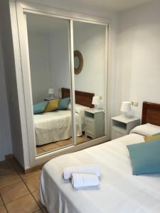 a bedroom with two beds and a large mirror at Vinaros Cala Montero 2 in Vinarós +20 photos