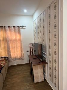 a living room with a couch and a table at The elf stays in Dehradun +2 photos