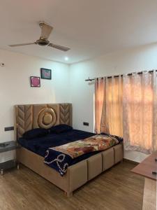 a bedroom with a bed and a ceiling at The elf stays in Dehradun