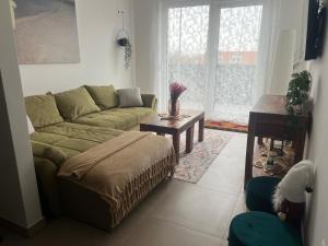a living room with a couch and a table at BLANK apartman u centru in Bjelovar