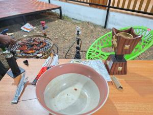 a bowl of food on a table with a grill at Dreamwagon hotel lakkidi in Vythiri