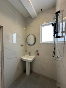 a white bathroom with a sink and a mirror at Andrew Transit Villa - Near Airport in Katunayaka