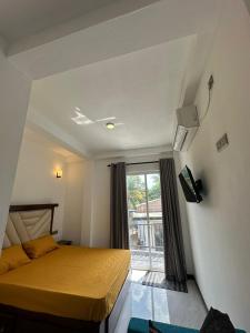a bedroom with a bed and a large window at Andrew Transit Villa - Near Airport in Katunayaka