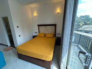 a bedroom with a bed and a balcony at Andrew Transit Villa - Near Airport in Katunayaka