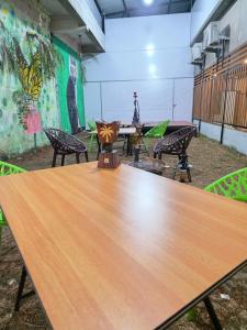 a large wooden table in a room with chairs at Dreamwagon hotel lakkidi in Vythiri