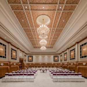 an empty banquet hall with chairs and a chandelier at Hotel Highway Prince Behror in Behror