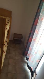 a row of bunk beds in a room with a window at Apartmani kod Rade in Pakoštane