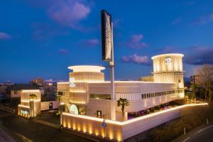 a large white building with a sign in front of it at Hotel The Moon -Adult Only- in Okayama