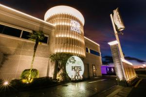 a hotel with a lit up building at night at Hotel The Moon -Adult Only- in Okayama