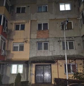 an old building with a door and windows at Trusted Home in Târgovişte