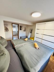 a bedroom with a large bed with two pillows on it at Ferienhäuser Radebeul "Apartment Altkötzschenbroda" in Radebeul +11 photos
