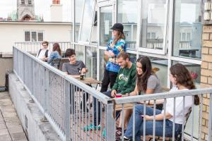 a group of people sitting on a balcony at Garden Lane Backpackers in Dublin