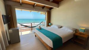 a bedroom with a bed with a view of the ocean at Hotel Punta del Mar in Máncora Chico +116 photos