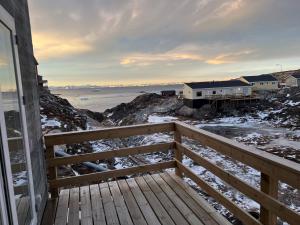 a view of the ocean from a balcony of a house at Private apartment with panoramic ocean views in Ilulissat