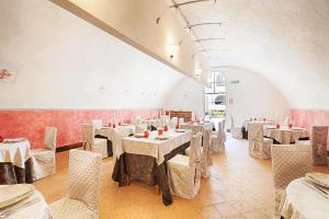 a dining room with tables and chairs in a room at Castello Di Compiano Hotel Relais Museum in Compiano
