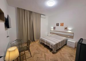 a hotel room with a bed and a glass table at Elycon House Bergamo - Locazione turistica a camere in Bergamo