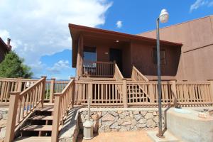 a house with a staircase leading to a porch at Crown Point Resort, by VRI Americas in Ruidoso