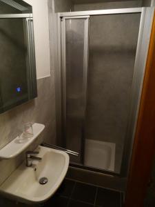 a bathroom with a sink and a shower at Bed&Breakfast Eifelpension Brückenschenke in Fuchshofen +32 photos