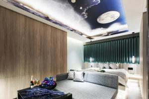 a bedroom with a bed and a mural of a moon at Hotel The Moon -Adult Only- in Okayama