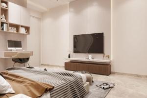 a living room with a tv and a bed and a chair at Jugnu hotel in Rohtak