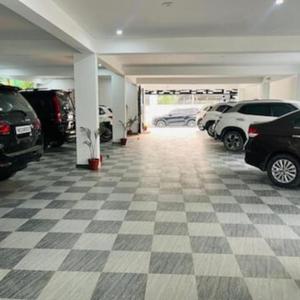 a parking garage with cars parked in it at Jugnu hotel in Rohtak
