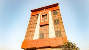 a tall building with an orange and white at Jugnu hotel in Rohtak