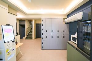 a room with white cabinets and a room with stairs at Hotel Remi in Seoul