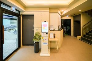 an office lobby with a desk and a sign at Hotel Remi in Seoul