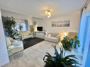 a living room with two couches and a tv at FeWo mit Terrasse Neuwied & Koblenz in Neuwied