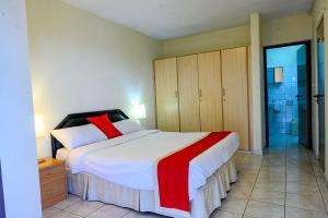 a bedroom with a large bed and a bathroom at Residency by LMR in Kigali
