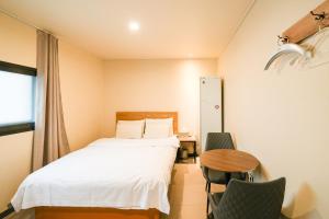 a bedroom with a bed and a table and chairs at Hotel Remi in Seoul +35 photos