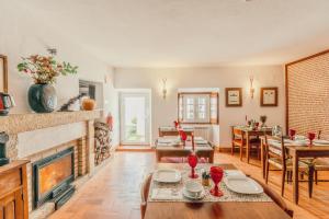 a living room with a fireplace and a dining room at Dom Dinis Marvão in Marvão