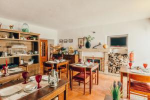 a living room with tables and chairs and a fireplace at Dom Dinis Marvão in Marvão