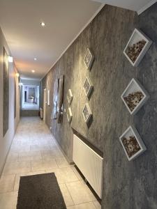 a hallway with a wall of pictures on the wall at Noclegi Adriana Kacperska in Tuszyn