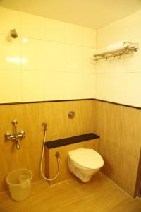 a bathroom with a toilet and a shower at HOTEL GRAND PLAZzA in Coimbatore +33 photos