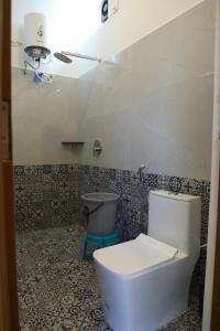 a bathroom with a toilet and a sink at Hill Woods Yelagiri in Yelagiri +10 photos