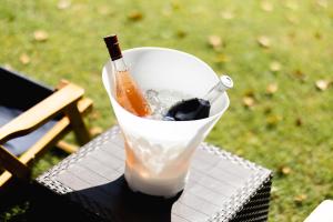 a bottle of drink in a cup on a table at Drinski sjaj in Ljubovija