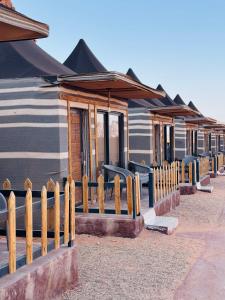 a wooden fence in front of a house at DESERT HELO lUXURY CAMP & TOUR in Wadi Rum