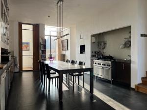 a kitchen with a dining table and chairs in a room at De Hoffstee in Minnertsga