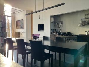 a kitchen with a table and some chairs and a stove at De Hoffstee in Minnertsga +36 photos