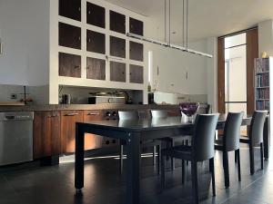 a kitchen with a dining room table and chairs at De Hoffstee in Minnertsga