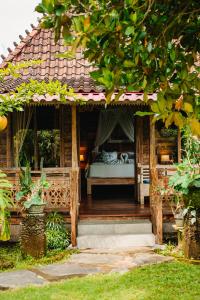 a wooden house with a bed in the middle at Nauna Villa Bali in Ubud +51 photos