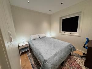 a bedroom with a bed and a window at Modern apartment in Drammen