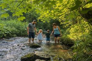 a family standing in a stream in a river at Črjanski Raj in Črna na Koroškem +47 photos