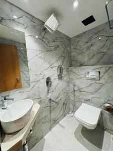a bathroom with a sink and a toilet at Hotel Comfort Castle in Mumbai +30 photos