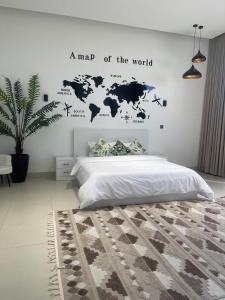 a bedroom with a map of the world on the wall at أستراحة بانا in Nizwa