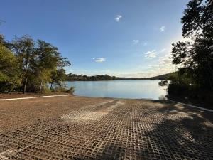 a road next to a body of water at Rancho Corumba VI in Alexânia +6 photos
