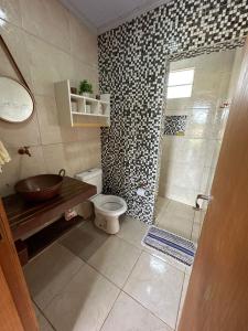 a bathroom with a sink and a toilet and a shower at Rancho Corumba VI in Alexânia