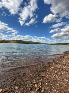 a view of a body of water with a rocky shore at Rancho Corumba VI in Alexânia