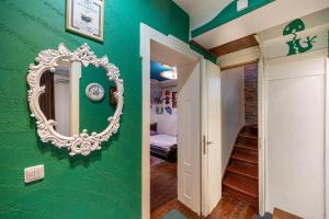 a green room with a mirror on a green wall at Central House for up to 20 Guests Entire Place in Sofia